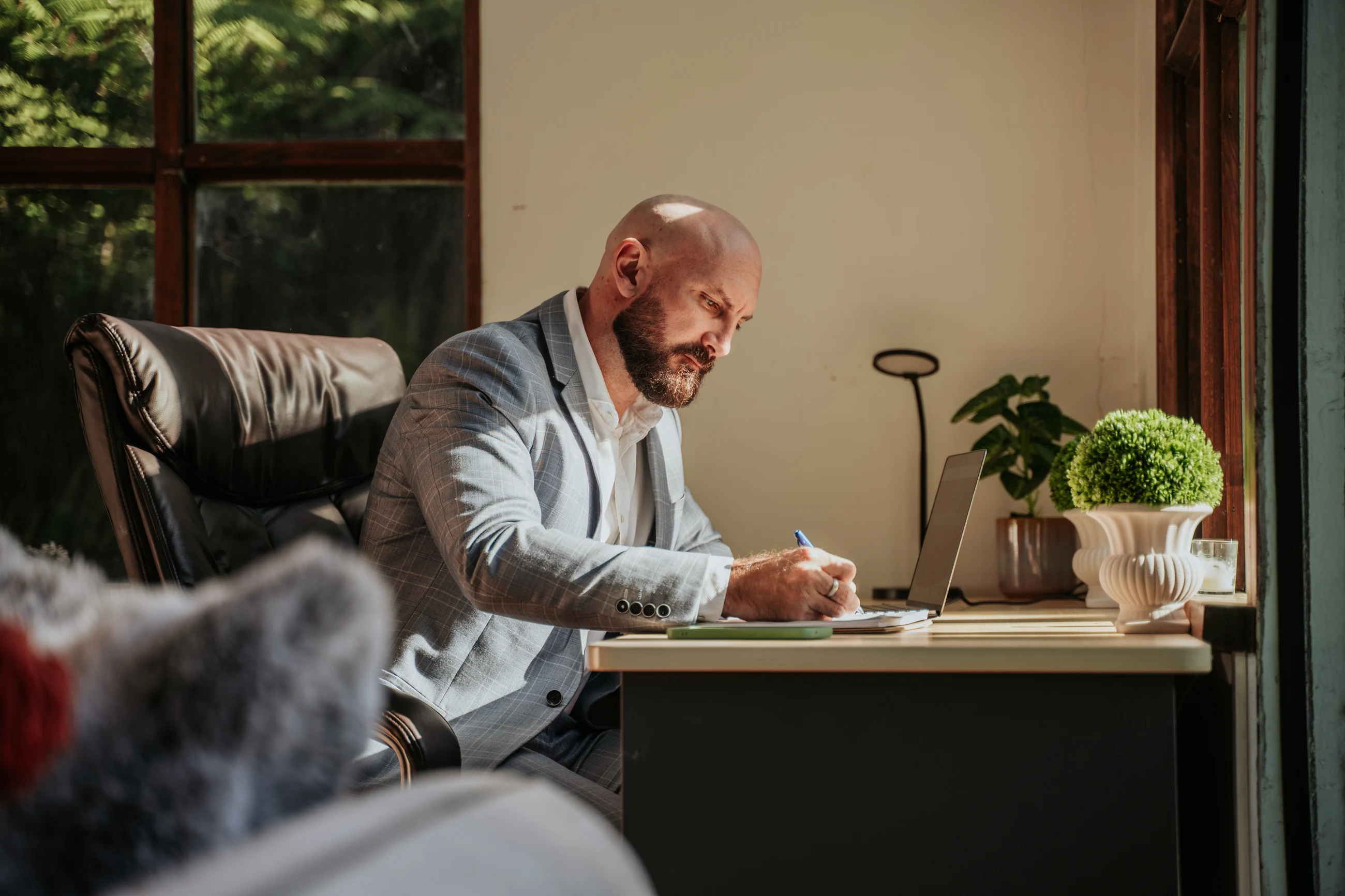 Andrew Metsa working through property research at a desk