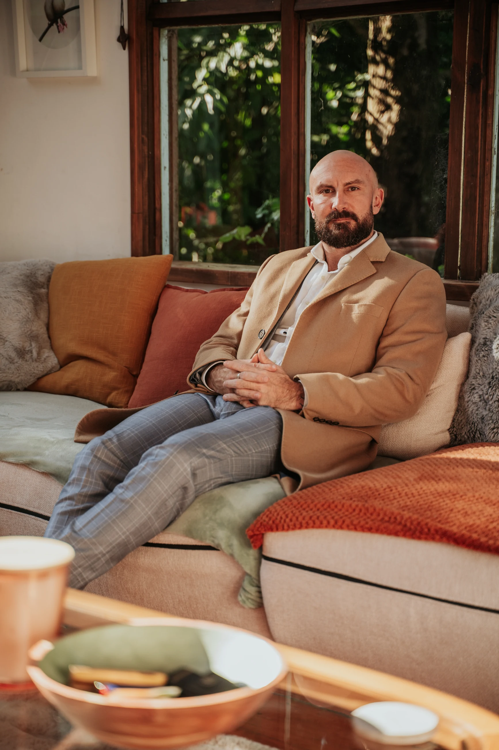 Andrew Metsa, founder of Keystone Advocacy, seated in a warm living room